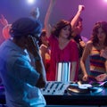 Male dj mixing music at party with dancing people Royalty Free Stock Photo