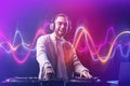 Male DJ playing music in club