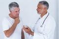 Male doctor advising senior man on medical prescriptions Royalty Free Stock Photo