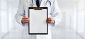 Male doctor with the blank clipboard in the clinic