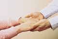 Mature female in elderly care facility gets help from hospital personnel nurse. Close up of aged wrinkled hands of senior woman. G Royalty Free Stock Photo