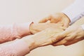 Mature female in elderly care facility gets help from hospital personnel nurse. Close up of aged wrinkled hands of senior woman. G Royalty Free Stock Photo