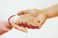 Mature female in elderly care facility gets help from hospital personnel nurse. Close up of aged wrinkled hands of senior woman. G Royalty Free Stock Photo