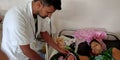 Male doctor checking baby health during treatment at ward