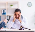 Male doctor in courthouse meeting with lawyer Royalty Free Stock Photo