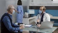 Male doctor doing medical consultation with old patient Royalty Free Stock Photo