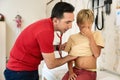 Male Doctor Examining Boy. Pediatrician examining boy patient with stethoscope. Royalty Free Stock Photo