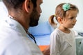 Male doctor examining a child patient in a hospital Royalty Free Stock Photo