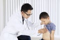 Male doctor examining a child patient Royalty Free Stock Photo