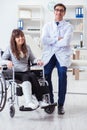 The male doctor examining female patient on wheelchair Royalty Free Stock Photo