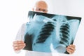 Male doctor examining the patient chest x-ray film lungs scan at radiology department in hospital.Covid-19 scan body xray test Royalty Free Stock Photo