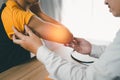 Male doctor examining a patient who has been injured or has pain in the arm. Royalty Free Stock Photo