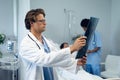 Male doctor examining x-ray report in the ward Royalty Free Stock Photo