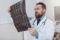 Male doctor examining x-ray scan at his office Royalty Free Stock Photo