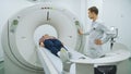 Male doctor exminating woman on mri machine Royalty Free Stock Photo