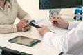 Male doctor explaining diagnosis to patient. Woman patient looking worried when listening bed news Royalty Free Stock Photo