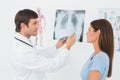 Male doctor explaining lungs xray to female patient