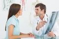 Male doctor explaining spine xray to female patient Royalty Free Stock Photo