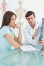 Male doctor explaining spine xray to female patient Royalty Free Stock Photo