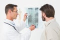 Male doctor explaining spine xray to patient Royalty Free Stock Photo
