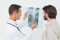 Male doctor explaining spine xray to patient Royalty Free Stock Photo