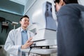 a male doctor and a female patient doing an eye check using a device Royalty Free Stock Photo