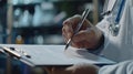 Male doctor filling up medical form in hospital office. Close-up of male hands holding silver pen. Royalty Free Stock Photo