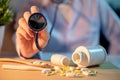 Male doctor hand holding stethoscope over pills on the desk Royalty Free Stock Photo