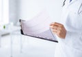 Male doctor hands holding cardiogram