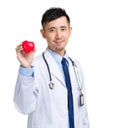 Male doctor with heart shape ball