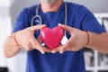 Male doctor hold in arms red heart Royalty Free Stock Photo