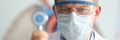 Male doctor hold in hand stethoscope with coronavirus symbol closeup.