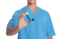 Male doctor holding asthma inhaler on white background. Medical object Royalty Free Stock Photo