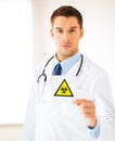 Male doctor holding boihazard caution sign Royalty Free Stock Photo