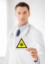 Male doctor holding coronavirus caution sign Royalty Free Stock Photo