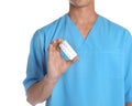 Male doctor holding pills on white background. Medical object Royalty Free Stock Photo