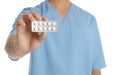 Male doctor holding pills on white background. Medical object Royalty Free Stock Photo