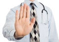 Male doctor holding up his hand in a Halt or Stop gesture