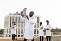 Male doctor holding x-ray scan of patient during break outdoors hospital. Royalty Free Stock Photo