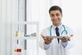 Male doctor hooked up a stethoscope, raised the medicine tray with both hands, held to the front Royalty Free Stock Photo