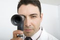 Male Doctor Looking Through Ophthalmoscope Royalty Free Stock Photo