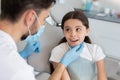 Male doctor looking at small client sitting in the dental chair Royalty Free Stock Photo