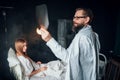 Male doctor looking at x-ray picture of sick woman