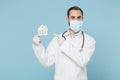 Male doctor man in gown face mask gloves isolated on blue background. Epidemic pandemic coronavirus 2019-ncov sars covid