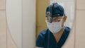 Male doctor man in medical mask physician surgeon medic looking in mirror hospital clinic washing hands disinfect wash Royalty Free Stock Photo