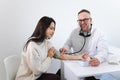Male doctor at the medical examination measures the blood pressure of a woman patient. Royalty Free Stock Photo