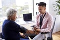 Male Doctor In Office Checking Senior Female Patients Blood Pressure Royalty Free Stock Photo