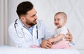 Male Doctor Pediatrician Examining Little Baby Girl In Clinic Indoors Royalty Free Stock Photo