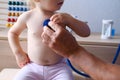 Male doctor pediatrician uses a stethoscope gadget to examine the health of a little patient, baby, little child helps, the Royalty Free Stock Photo
