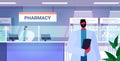 male doctor pharmacist with clipboard standing at pharmacy counter modern drugstore interior medicine